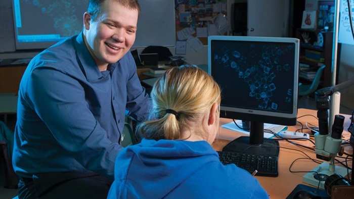 Man and woman working at a computer.